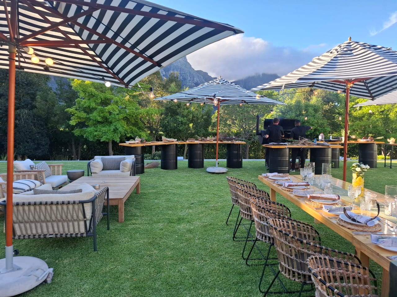 Outdoor tables beneath striped umbrellas